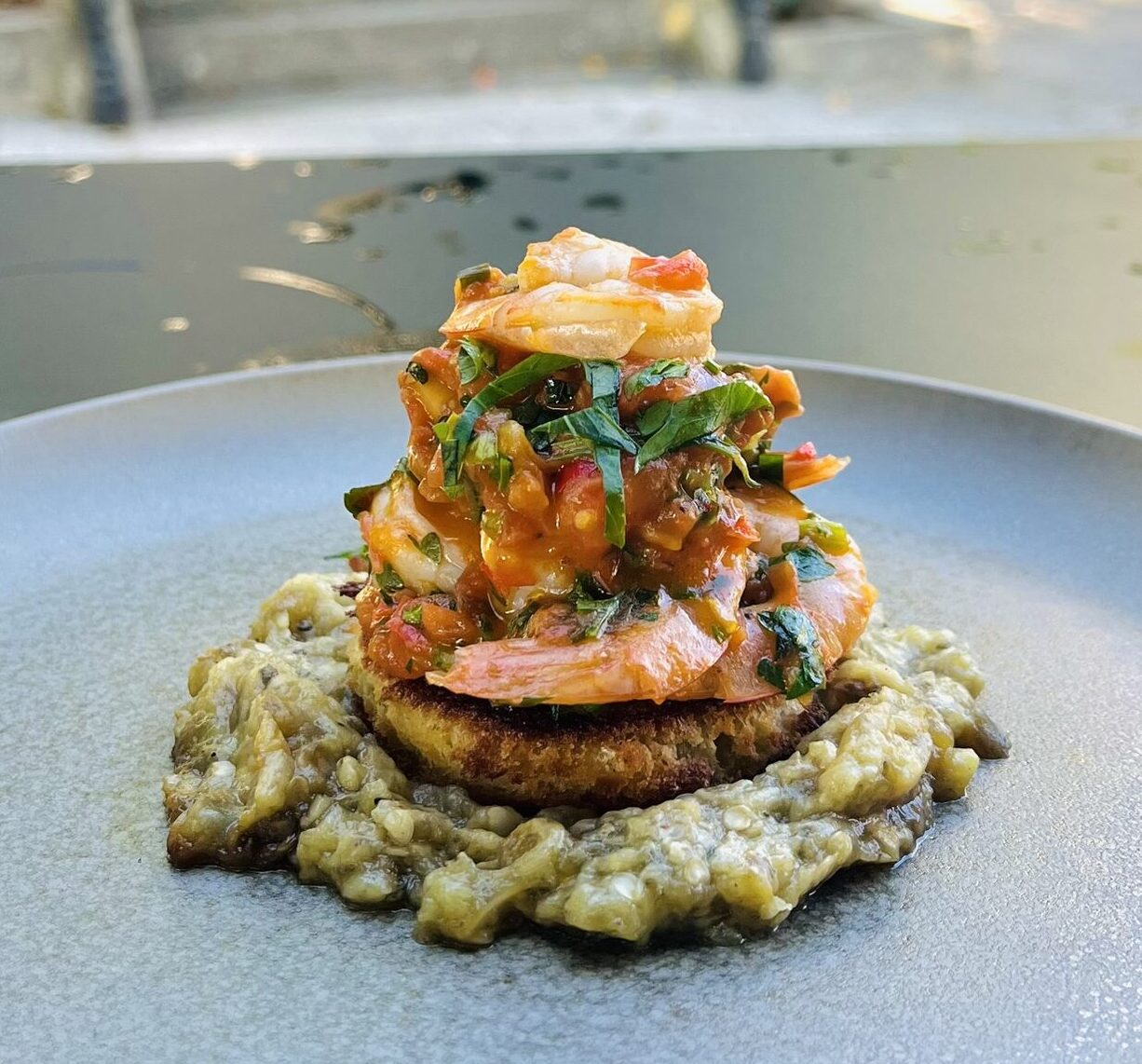 Plated gourmet Mediterranean dish prepared by the chef at Bistro Lua restaurant in Caldelas.
